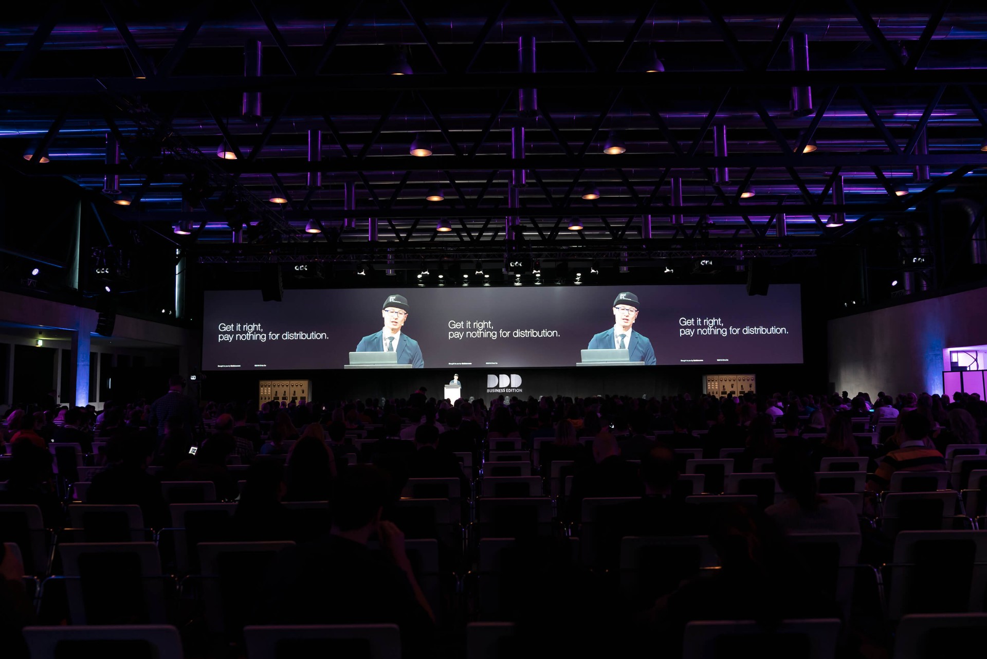 Chris Do speaking at a conference stage
